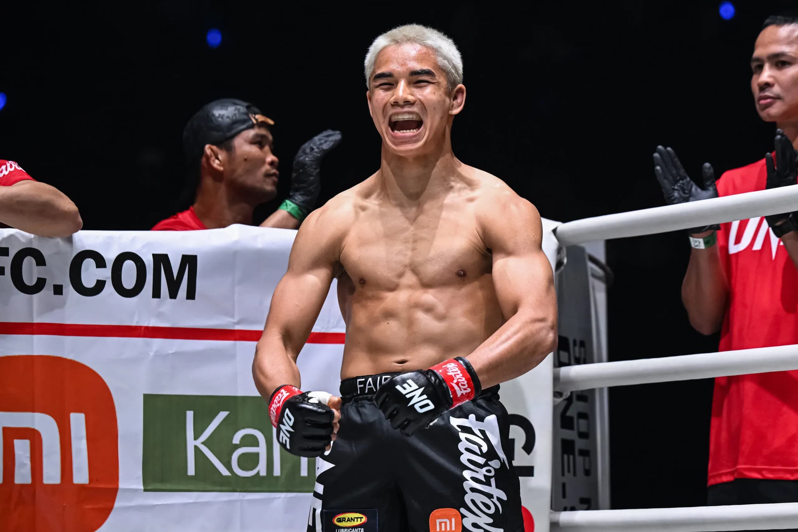 Malaysian-American fighter Johan Ghazali flexes with his bleached blond hair