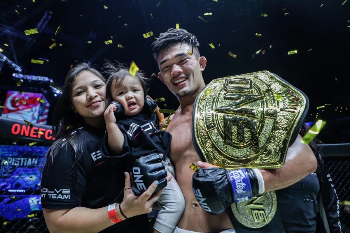 MMA star Christian Lee with the belt and his family