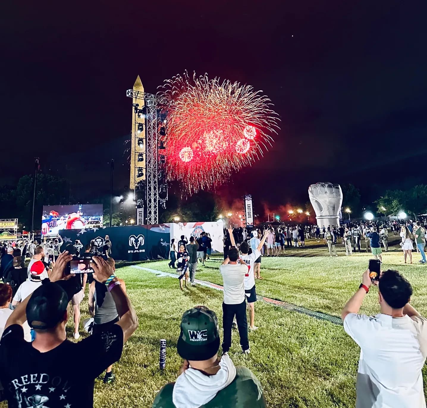 Red fireworks burst over the Washington Monument at UFC Freedom 250