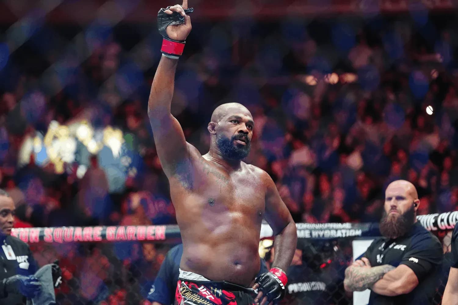 Jon Jones celebrates inside the octagon.