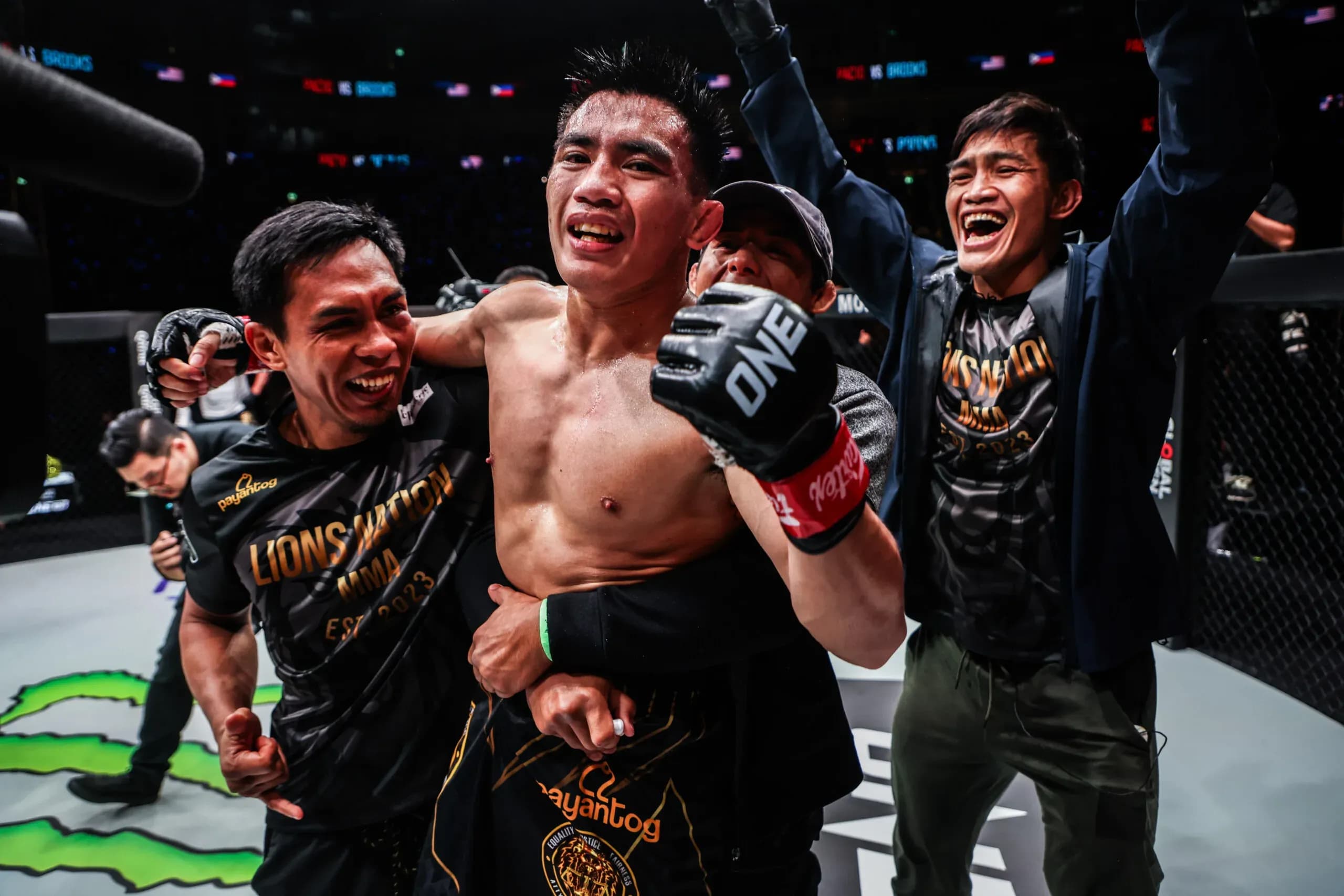 Filipino MMA fighter Joshua Pacio celebrates a win with his team