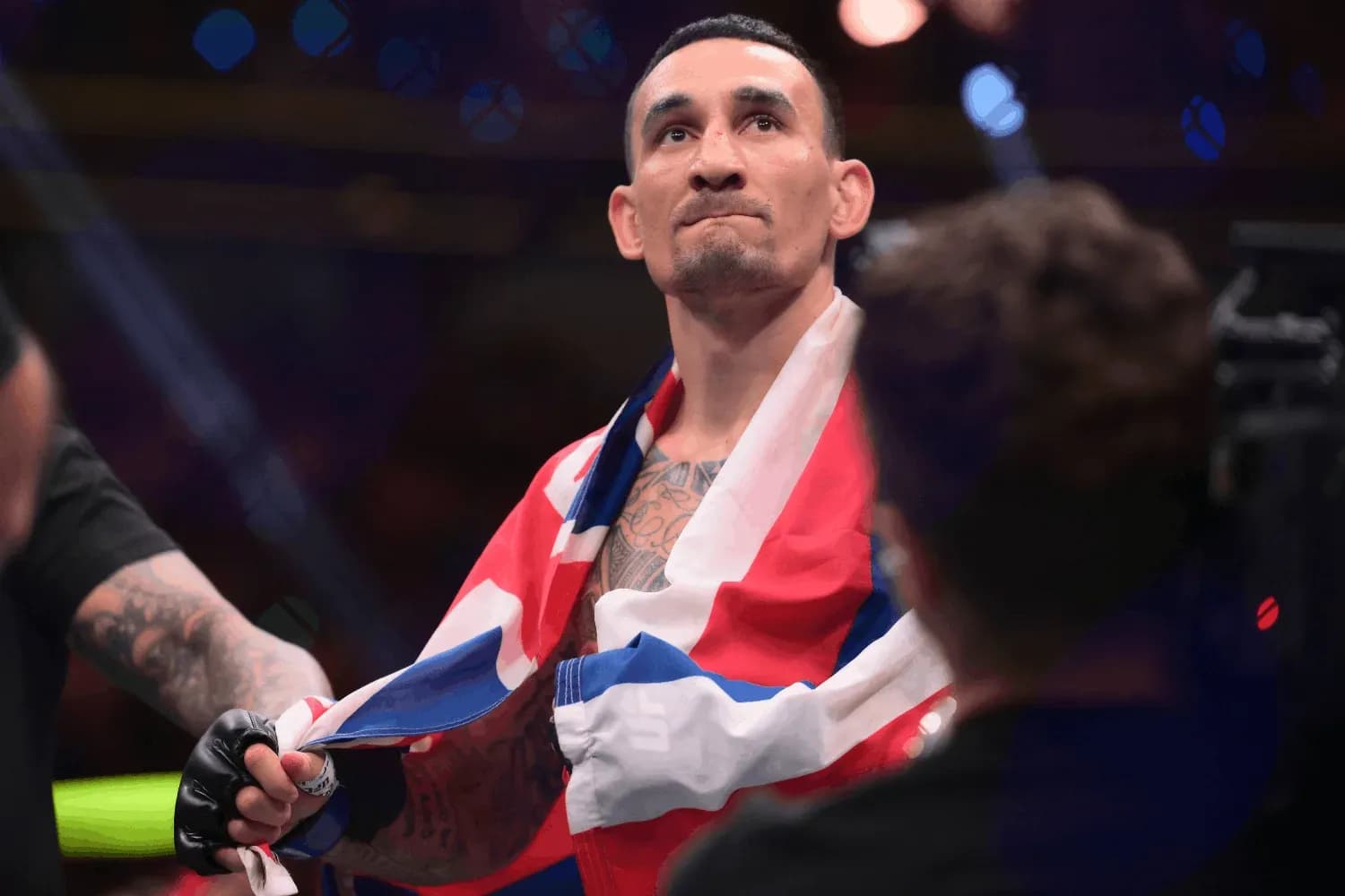 Max Holloway celebrates with the American flag after beating Conor McGregor