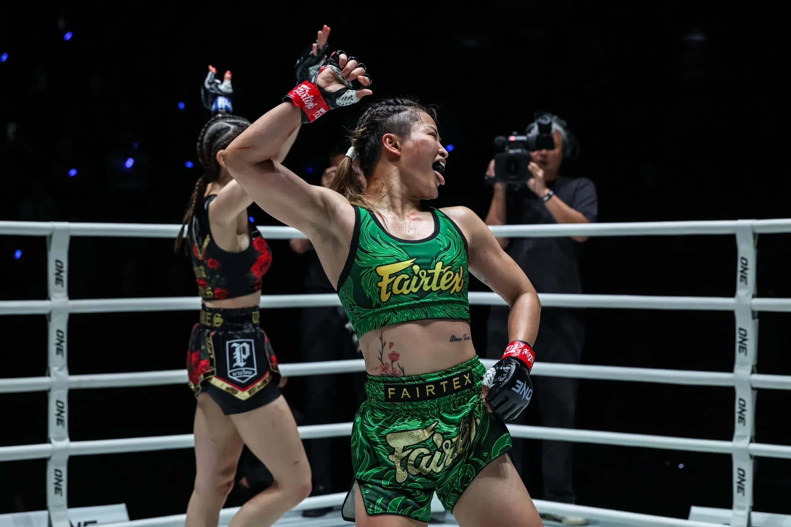 MMA fighter Stamp Fairtex dances following her Muay Thai victory