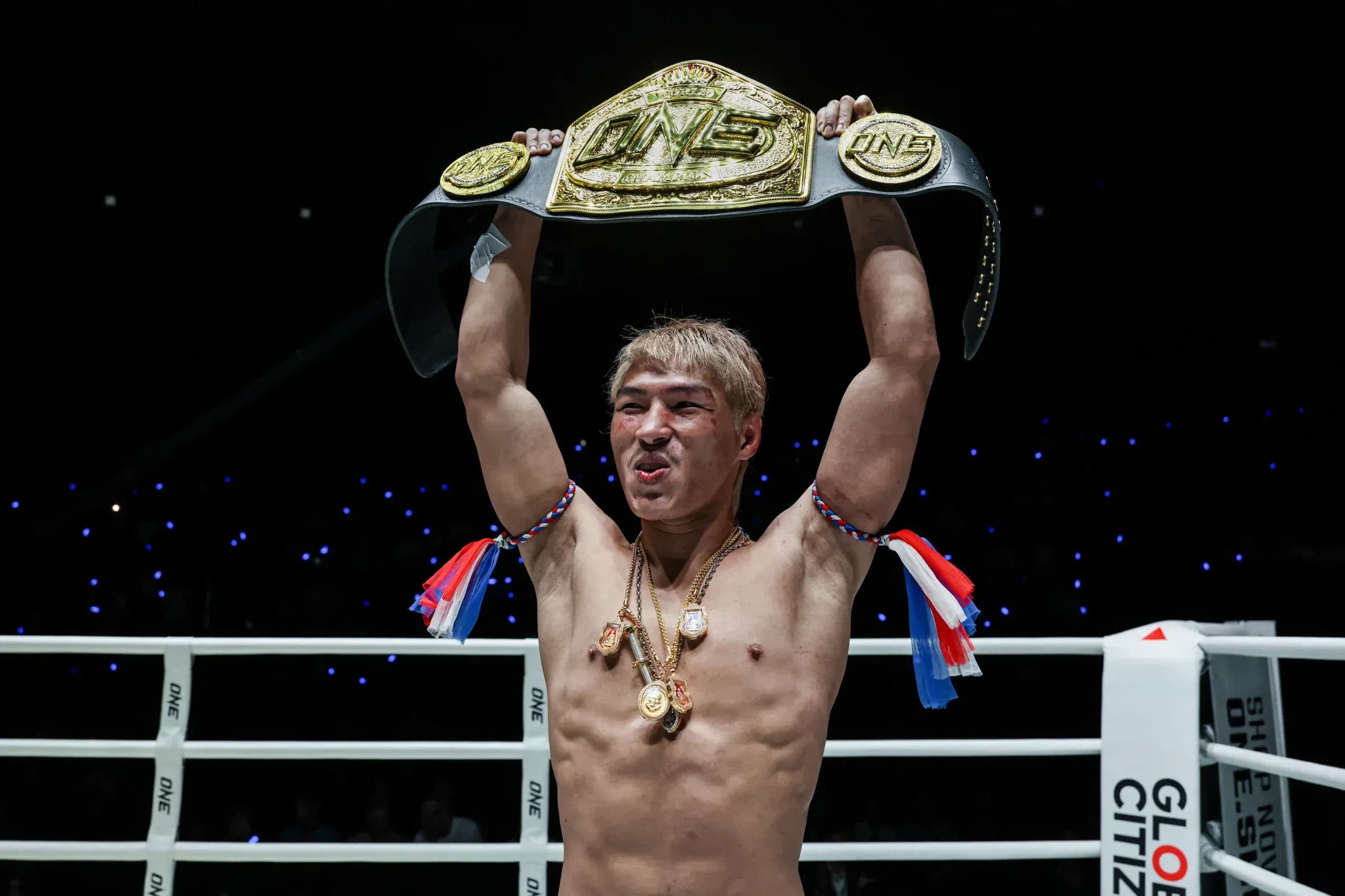Muay Thai fighter Yod-IQ holds the ONE Championship belt over his head